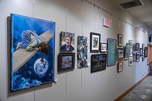 2022 Members' Show at the Public Library for Union County this photograph shows several paintings and photographs hanging on the wall