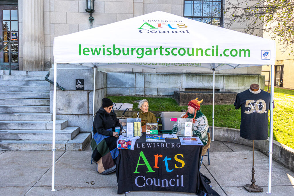 Lewisburg Arts Council tent with volunteers during the Stroll Through the Arts event in Lewisburg.