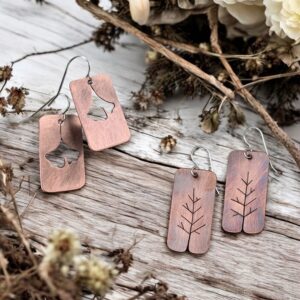 copper earrings with pierced designs of gingko leaves and trees